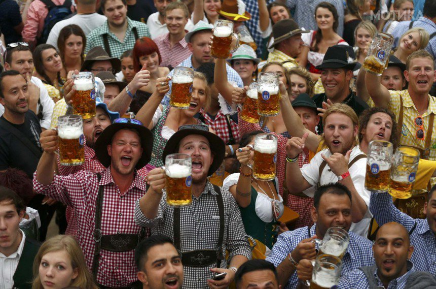 Visitors toast with their one-liter beer mugs during opening day of 181st Oktoberfest in Munich