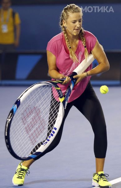 Two-times Australian Open tennis champion Victoria Azarenka of Belarus uses a giant racquet to hit a ball during a charity event on Rod Laver Arena at Melbourne Park