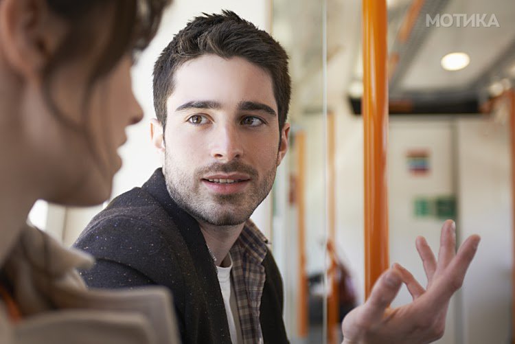 man talking to woman in train