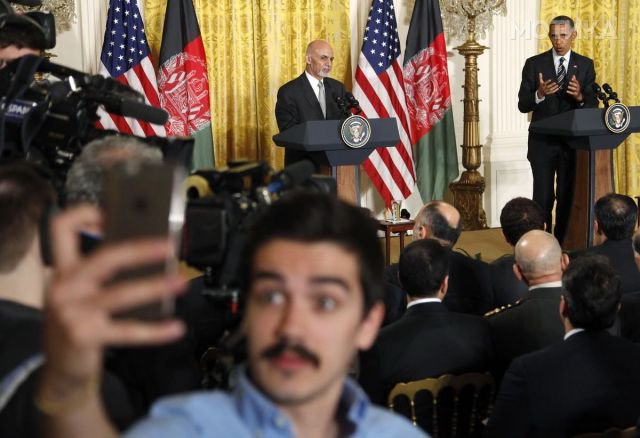 An Afghan journalist takes a "selfie" as U.S. President Obama and Afghan President Ghani hold joint news conference at the White House in Washington