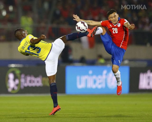 Ecuador's Valencia and Chile's  Aranguiz jump for the ball during the opening soccer match of the Copa America 2015 at the National Stadium in Santiago