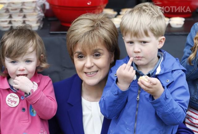 Shari Watson,Scotland's First Minister Nicola Sturgeon and Callum Boswell taste a strawberry tart at the young farmers stand at the Royal Highland Show Edinburgh, Scotland