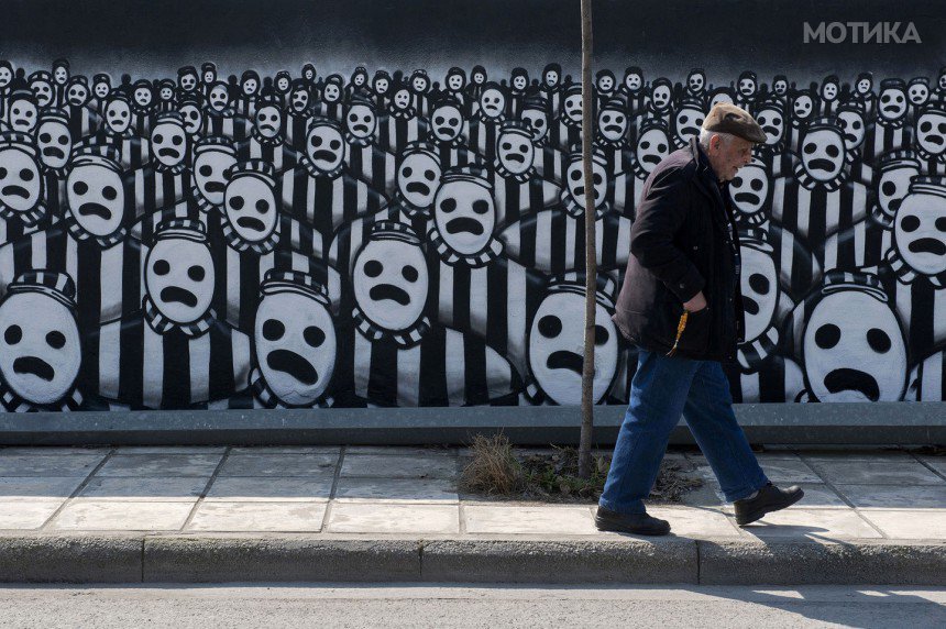 A man walks past a graffiti dedicated to the Holocaust in the northern port city of Thessaloniki