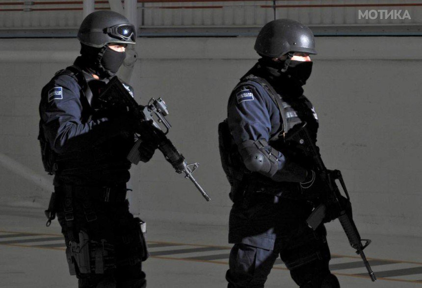 Policemen walk during a press conference