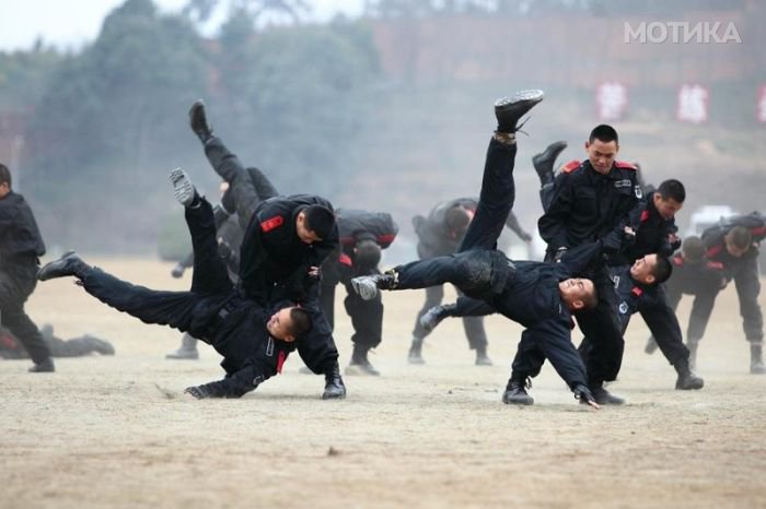 Paramilitary policemen practise combat skills during a drill at a training base in Deyang