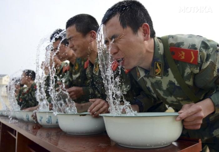 Paramilitary police snipers raise their heads from basins of water during a practice session of holding their breaths underwater at an annual drill in Nanjing