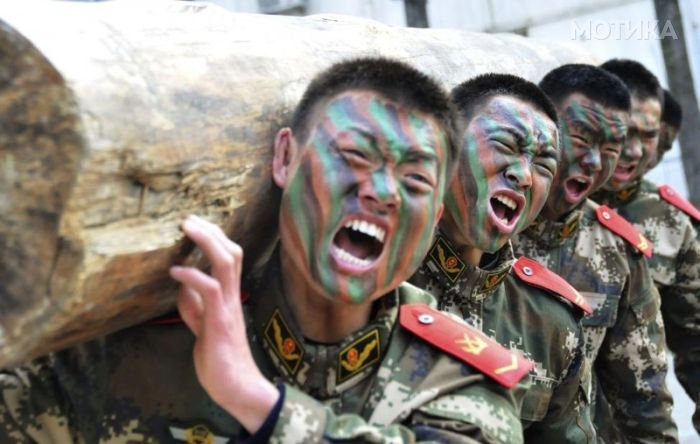 Paramilitary policemen shout as they lift a log during a winter training session at a military base in Chaohu