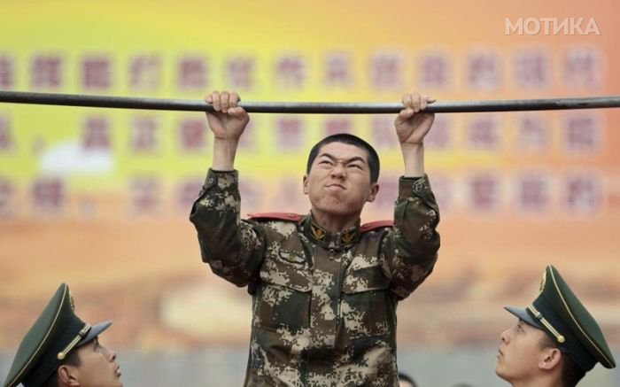 A new paramilitary recruit does pull-ups during an examination after training in preparation for real-life rescue tasks in Nanjing