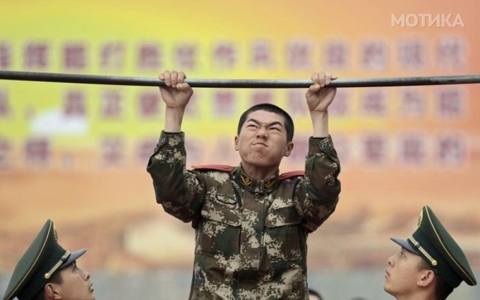 A new paramilitary recruit does pull-ups during an examination after training in preparation for real-life rescue tasks in Nanjing