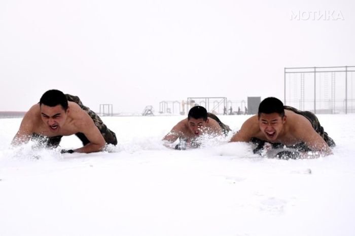 Paramilitary policemen practise during a winter training session at a snow field in Kashgar